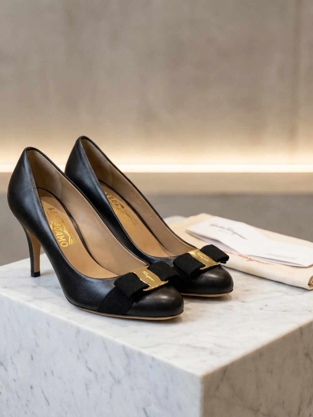 Black leather gold bow buckle Salvatore Ferregamo heels. Size 7
